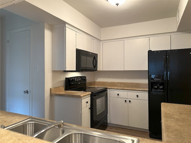 6036 Birchbrook Dr Unit 127, Dallas, TX 75206 - kitchen featuring black appliances, white cabinetry, and light countertops