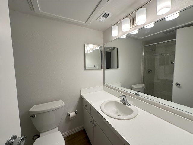 6036 Birchbrook Dr Unit 127, Dallas, TX 75206 - bathroom featuring tiled shower, vanity, and wood finished floors
