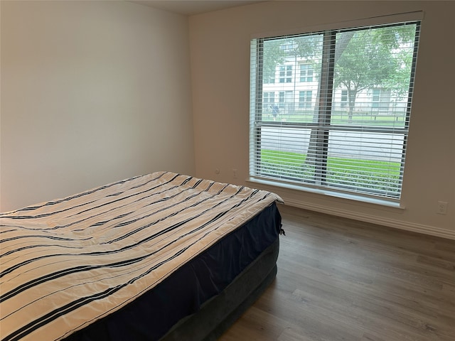 6036 Birchbrook Dr Unit 127, Dallas, TX 75206 - bedroom with wood finished floors and baseboards