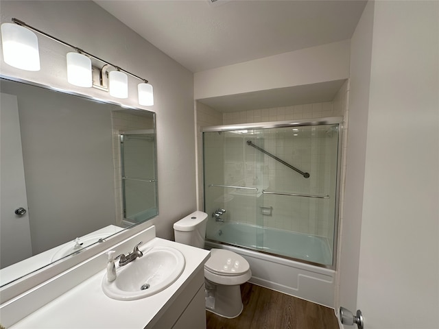 6036 Birchbrook Dr Unit 127, Dallas, TX 75206 - full bath featuring wood finished floors, vanity, and enclosed tub / shower combo