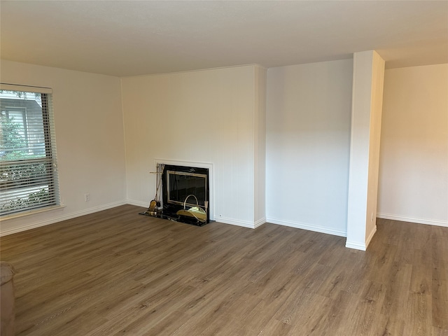6036 Birchbrook Dr Unit 127, Dallas, TX 75206 - unfurnished living room featuring wood finished floors and a fireplace with raised hearth