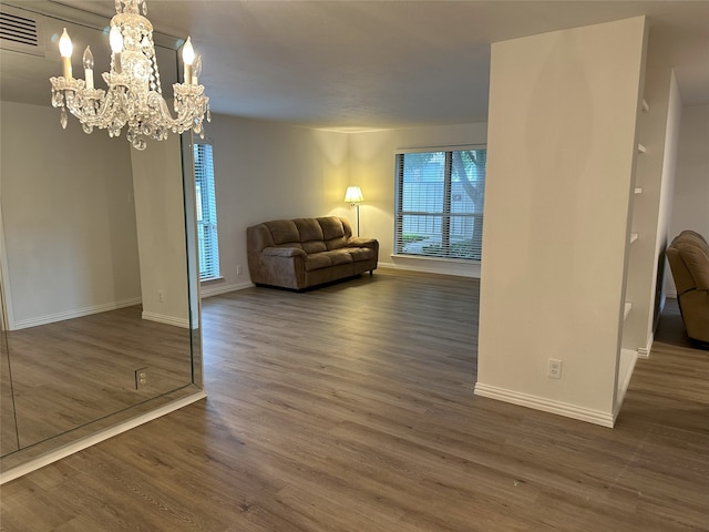 6036 Birchbrook Dr Unit 127, Dallas, TX 75206 - living area featuring wood finished floors and a chandelier
