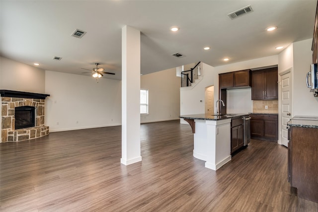 2740 Pease Dr, Forney, TX 75126 - kitchen with open floor plan, ceiling fan, dark stone countertops, appliances with stainless steel finishes, and decorative backsplash