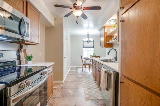 221 Sierra Dr, Joshua, TX 76058 - kitchen featuring stainless steel appliances, light countertops, open shelves, a ceiling fan, and a chandelier