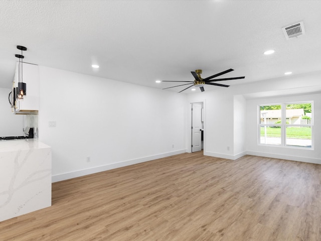 1910 Durham St, Irving, TX 75062 - unfurnished living room with light wood finished floors, recessed lighting, and ceiling fan