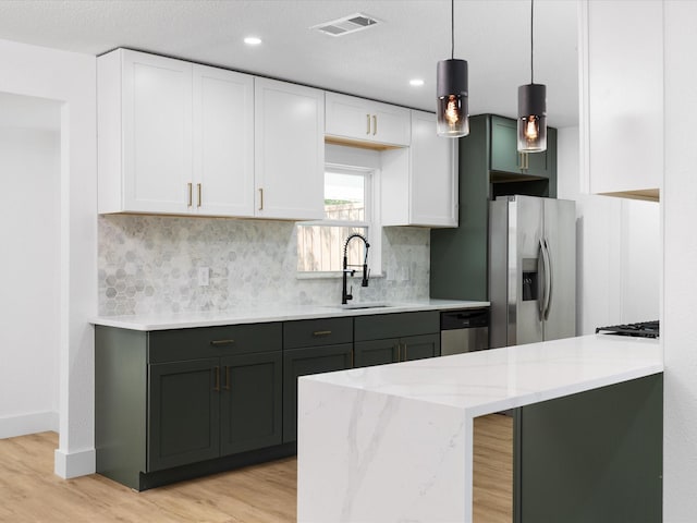 1910 Durham St, Irving, TX 75062 - kitchen featuring appliances with stainless steel finishes, white cabinets, tasteful backsplash, and recessed lighting