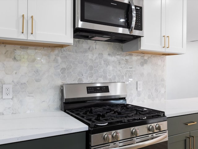 1910 Durham St, Irving, TX 75062 - kitchen featuring stainless steel appliances, backsplash, white cabinetry, and light stone counters