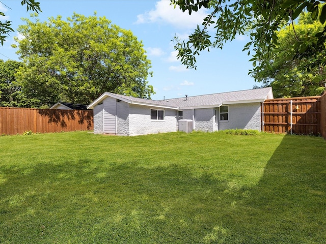 1910 Durham St, Irving, TX 75062 - back of property featuring brick siding and a fenced backyard