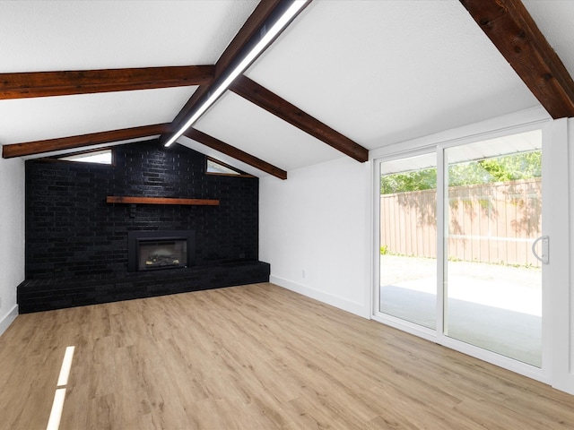1910 Durham St, Irving, TX 75062 - unfurnished living room with wood finished floors and a brick fireplace