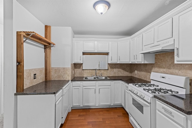 504 Cozby St N, Benbrook, TX 76126 - kitchen with gas range gas stove, under cabinet range hood, white cabinetry, and wood finished floors