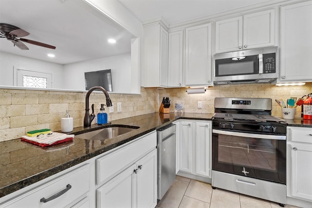 717 Thersa Dr, River Oaks, TX 76114 - kitchen with appliances with stainless steel finishes, dark stone counters, white cabinets, backsplash, and recessed lighting