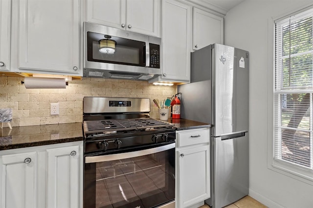 717 Thersa Dr, River Oaks, TX 76114 - kitchen featuring stainless steel appliances, decorative backsplash, white cabinets, and dark stone countertops