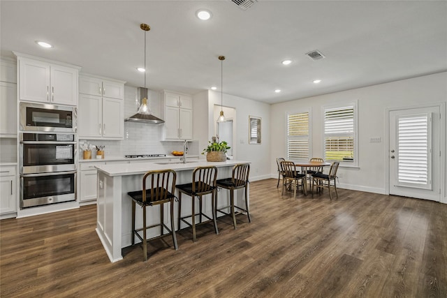 1430 Shaker Hills Rd, Gunter, TX 75058 - kitchen with wall chimney range hood, stainless steel appliances, dark wood-style flooring, light countertops, and backsplash