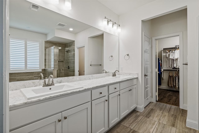 1430 Shaker Hills Rd, Gunter, TX 75058 - bathroom featuring tiled shower, double vanity, and a walk in closet