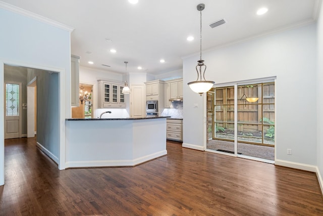 5913 Kensington Dr, Plano, TX 75093 - kitchen featuring appliances with stainless steel finishes, ornamental molding, dark countertops, dark wood-type flooring, and recessed lighting