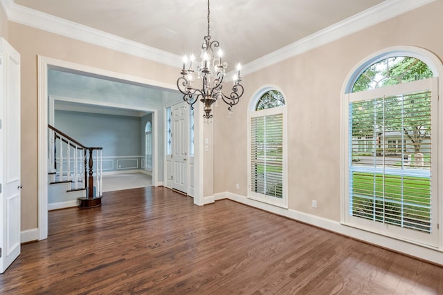 5913 Kensington Dr, Plano, TX 75093 - unfurnished dining area featuring a chandelier, wood finished floors, crown molding, and stairs