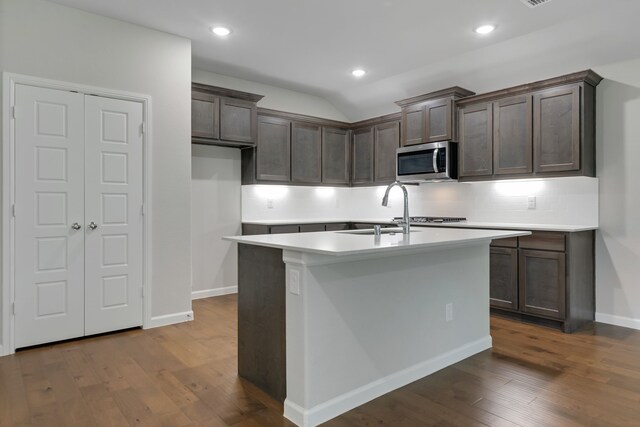 5524 Santa Elena Ct, Fort Worth, TX 76126 - kitchen featuring stainless steel microwave, light countertops, dark wood finished floors, dark brown cabinetry, and recessed lighting
