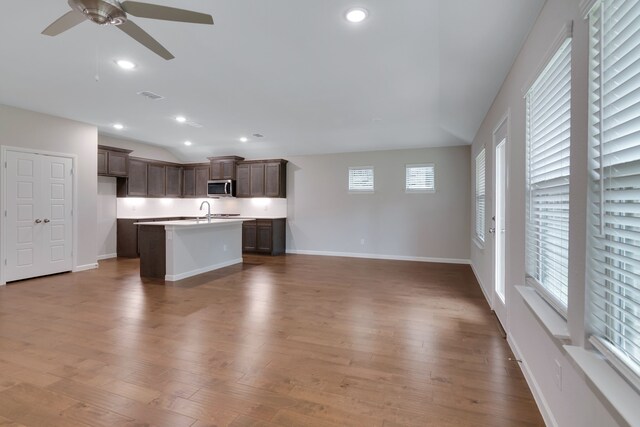 5524 Santa Elena Ct, Fort Worth, TX 76126 - kitchen featuring stainless steel microwave, open floor plan, ceiling fan, a center island with sink, and recessed lighting