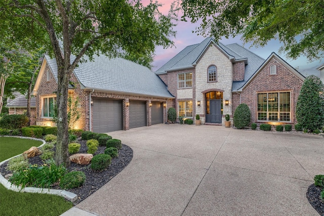 4637 Biltmoore Dr, Frisco, TX 75034 - view of front facade featuring a garage, brick siding, concrete driveway, and a high end roof