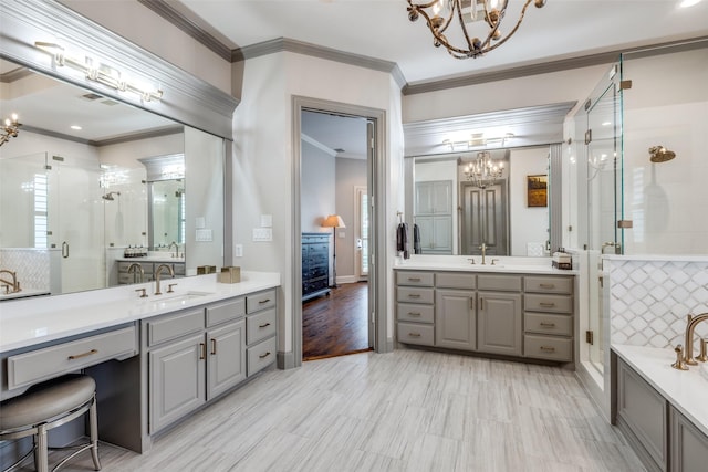 4637 Biltmoore Dr, Frisco, TX 75034 - full bathroom featuring a chandelier, a shower stall, two vanities, and crown molding