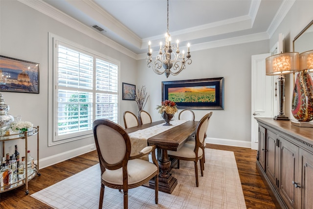 4637 Biltmoore Dr, Frisco, TX 75034 - dining space featuring a chandelier, dark wood-type flooring, a raised ceiling, and ornamental molding