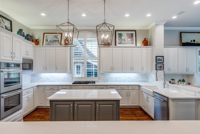 4637 Biltmoore Dr, Frisco, TX 75034 - kitchen featuring appliances with stainless steel finishes, ornamental molding, a chandelier, dark wood-style floors, and white cabinets