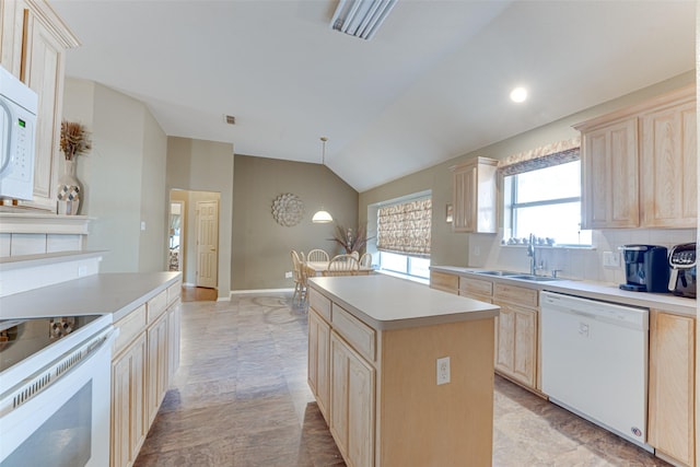 6905 Laurel Canyon Ter, Fort Worth, TX 76132 - kitchen with white appliances, light brown cabinetry, vaulted ceiling, light countertops, and recessed lighting