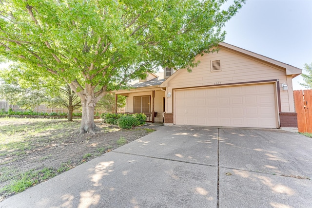 6905 Laurel Canyon Ter, Fort Worth, TX 76132 - obstructed view of property with brick siding, driveway, and an attached garage