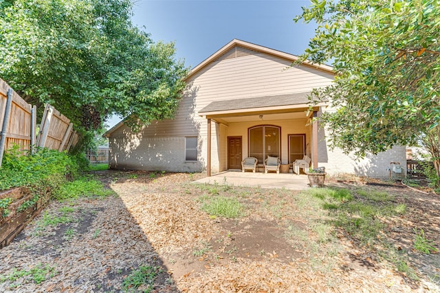6905 Laurel Canyon Ter, Fort Worth, TX 76132 - back of house featuring a patio area, a fenced backyard, and brick siding