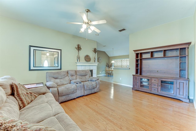6905 Laurel Canyon Ter, Fort Worth, TX 76132 - living area featuring wood finished floors, ceiling fan, vaulted ceiling, and a tiled fireplace