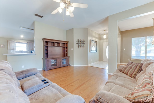 6905 Laurel Canyon Ter, Fort Worth, TX 76132 - living room featuring a ceiling fan, wood finished floors, and a chandelier