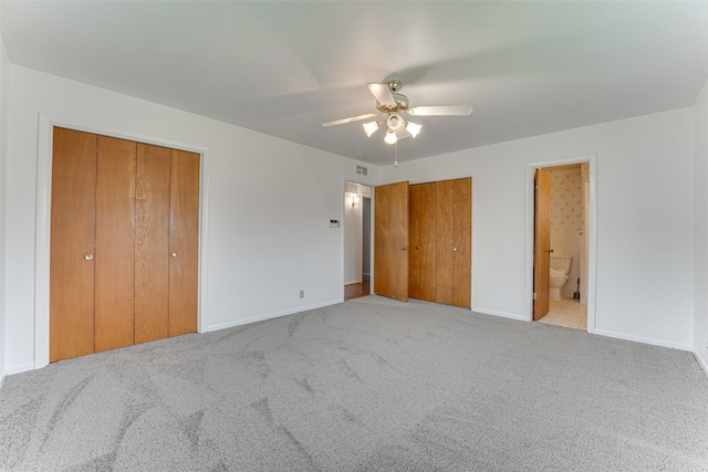 410 Ovilla Rd, Waxahachie, TX 75167 - unfurnished bedroom featuring multiple closets, carpet, ensuite bath, and ceiling fan
