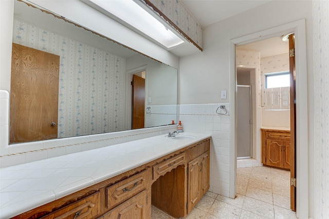 410 Ovilla Rd, Waxahachie, TX 75167 - bathroom with vanity, a stall shower, wallpapered walls, tile patterned flooring, and wainscoting