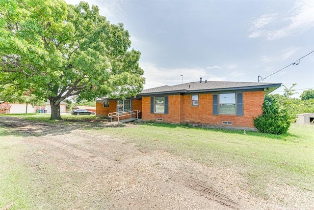 410 Ovilla Rd, Waxahachie, TX 75167 - view of front facade featuring brick siding, a front yard, and crawl space