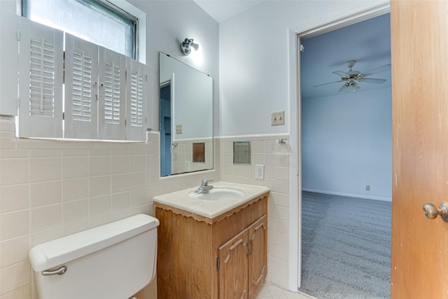 410 Ovilla Rd, Waxahachie, TX 75167 - half bath featuring vanity, a ceiling fan, tile walls, and a wainscoted wall