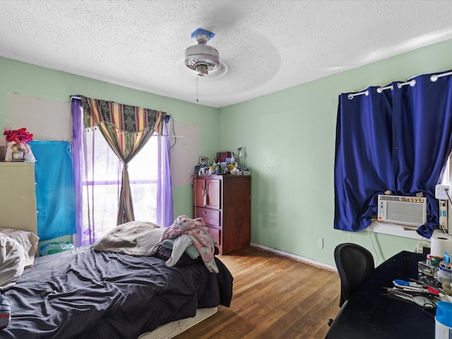 2232 E Kiest Blvd, Dallas, TX 75216 - bedroom with wood finished floors, cooling unit, a textured ceiling, and ceiling fan