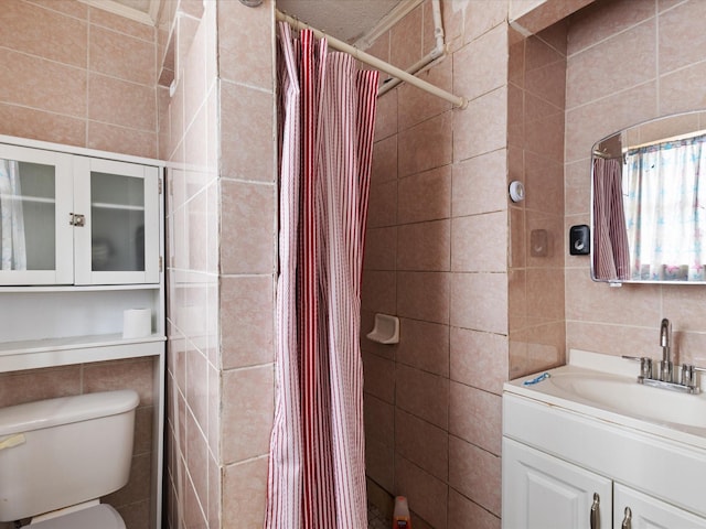 2232 E Kiest Blvd, Dallas, TX 75216 - full bathroom with tile walls, vanity, and tiled shower