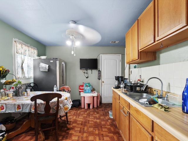 2232 E Kiest Blvd, Dallas, TX 75216 - kitchen featuring freestanding refrigerator, light countertops, and tasteful backsplash