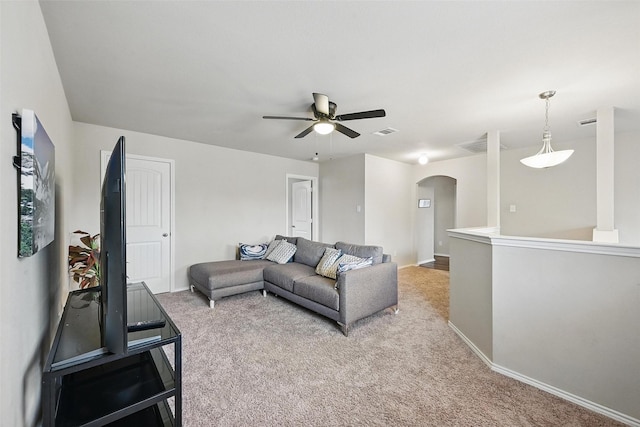 1209 Jasper Xing, Princeton, TX 75407 - living room with arched walkways, light colored carpet, and ceiling fan