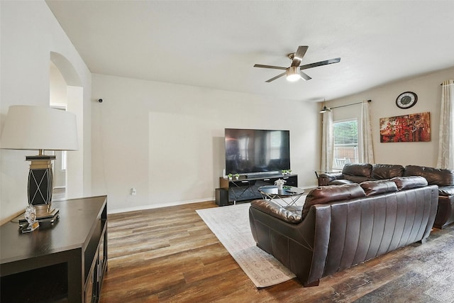 1209 Jasper Xing, Princeton, TX 75407 - living area with a ceiling fan, wood finished floors, and arched walkways