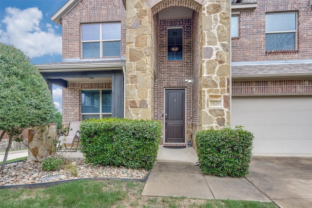 3820 Buchanan St, Mckinney, TX 75071 - doorway to property featuring brick siding, a garage, and stone siding