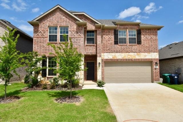 2609 Donella Dr, Denton, TX 76207 - view of front facade with a garage, concrete driveway, brick siding, and a front yard