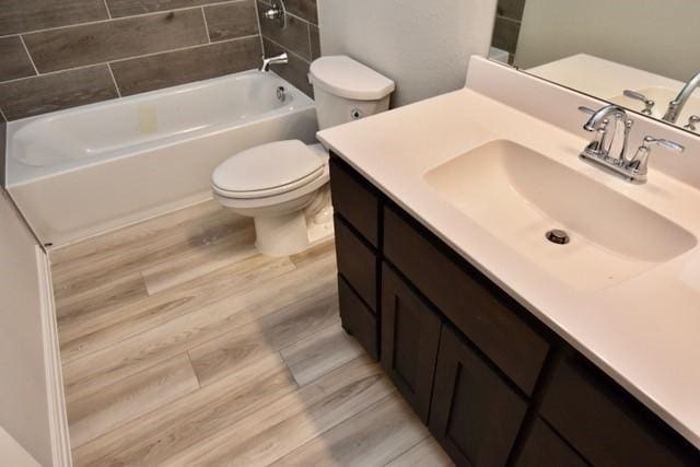 2609 Donella Dr, Denton, TX 76207 - full bathroom with vanity, shower / bath combination, and wood finished floors