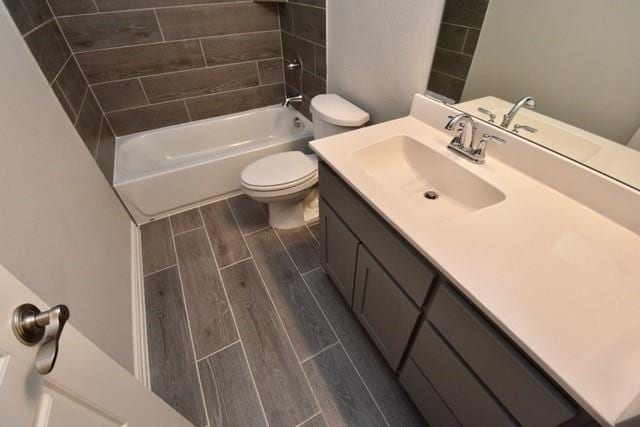 2609 Donella Dr, Denton, TX 76207 - bathroom featuring wood tiled floors, vanity, and shower / bathtub combination
