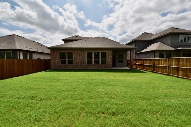 2609 Donella Dr, Denton, TX 76207 - rear view of property with a fenced backyard and brick siding