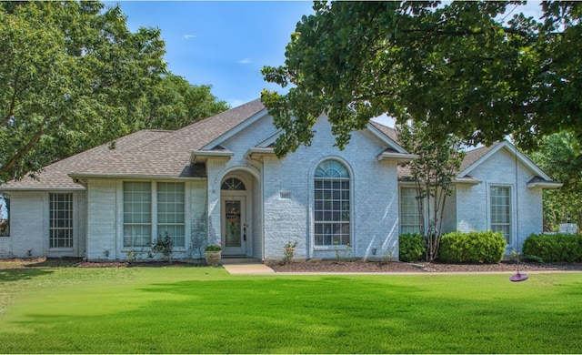 107 Suburban Dr, Ovilla, TX 75154 - view of front of property featuring a front lawn, brick siding, and roof with shingles