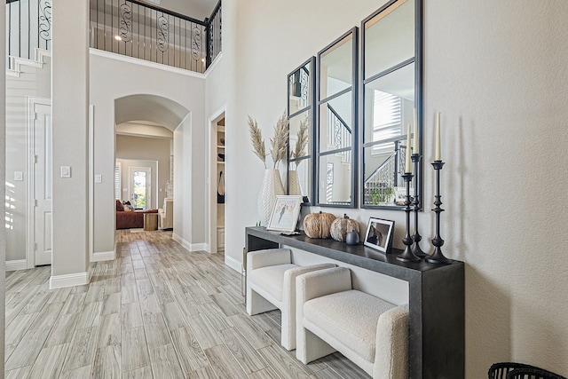 1701 Trinidad Way, Argyle, TX 76226 - corridor featuring arched walkways, a towering ceiling, and light wood-style floors