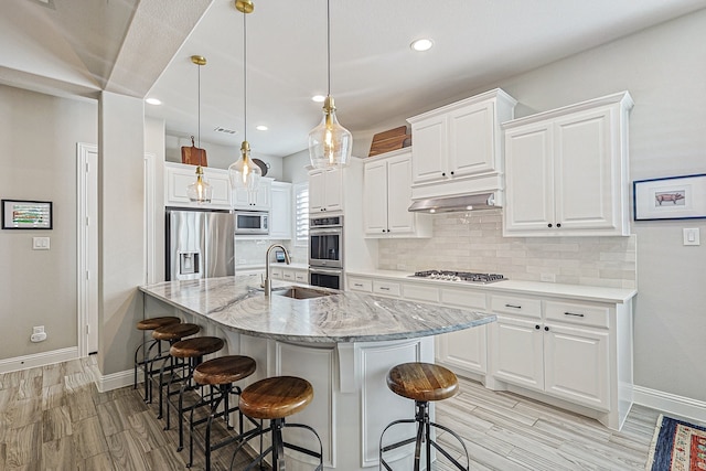 1701 Trinidad Way, Argyle, TX 76226 - kitchen with appliances with stainless steel finishes, decorative backsplash, light wood-type flooring, white cabinetry, and recessed lighting
