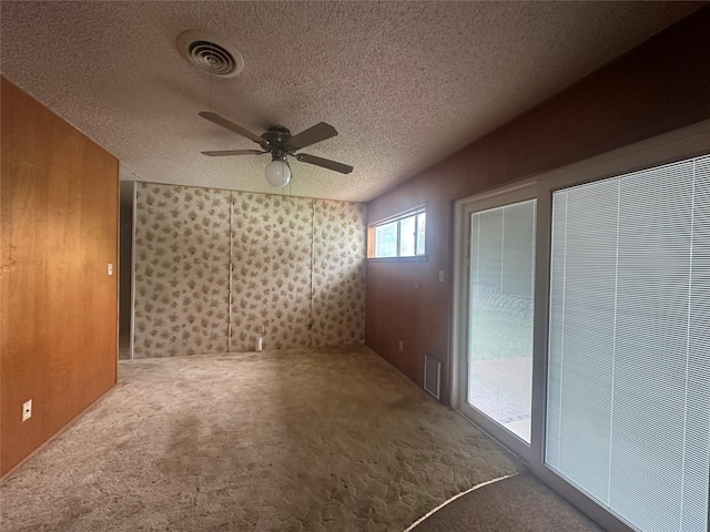 1916 11th St, Mineral Wells, TX 76067 - empty room with ceiling fan, carpet flooring, wallpapered walls, and a textured ceiling