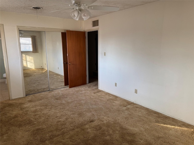 1916 11th St, Mineral Wells, TX 76067 - unfurnished bedroom featuring carpet flooring, a textured ceiling, and ceiling fan